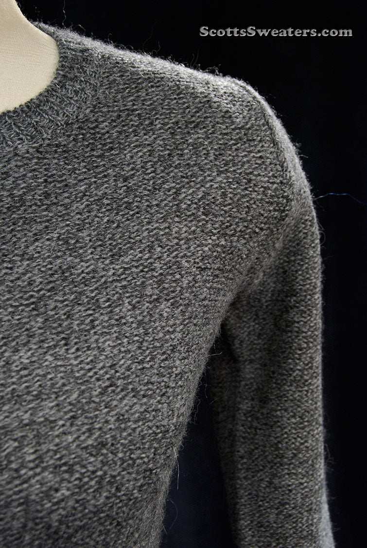 Close-up of a woman's grey alpaca-merino wool sweaterdress in X-Small size