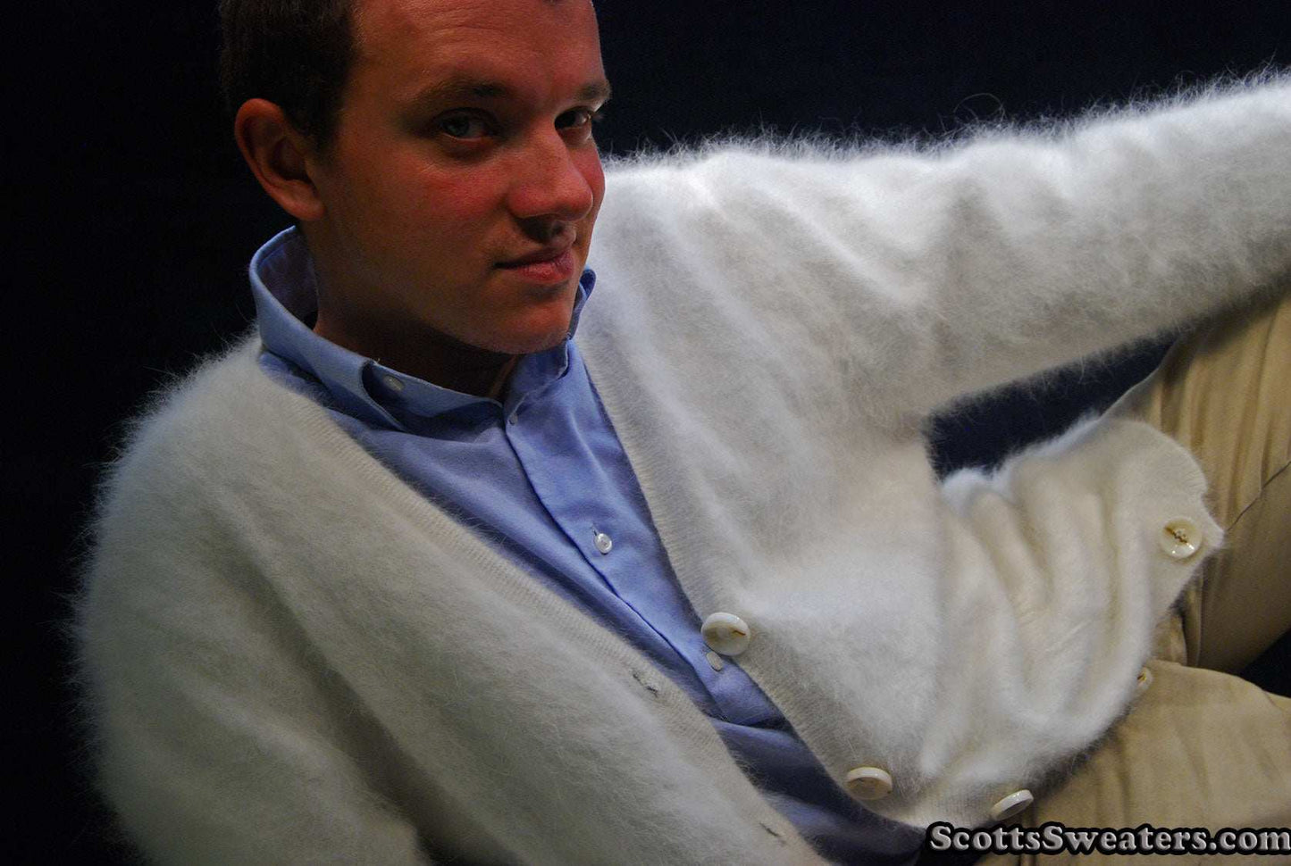 Men's ultra-soft angora cardigan sweater in white worn over a blue shirt