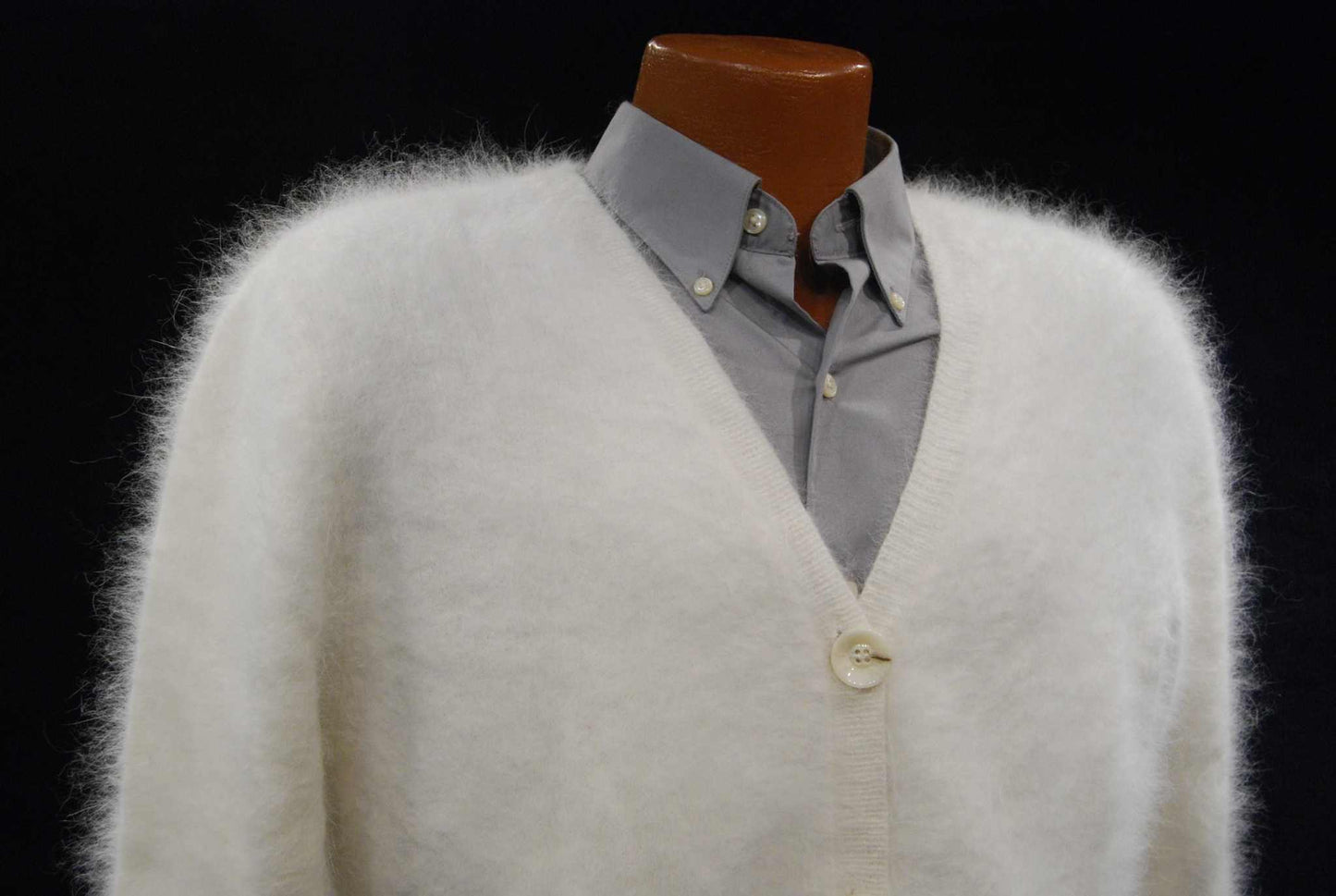 Men's ultra-soft angora white cardigan sweater on mannequin with button closure and gray shirt underneath