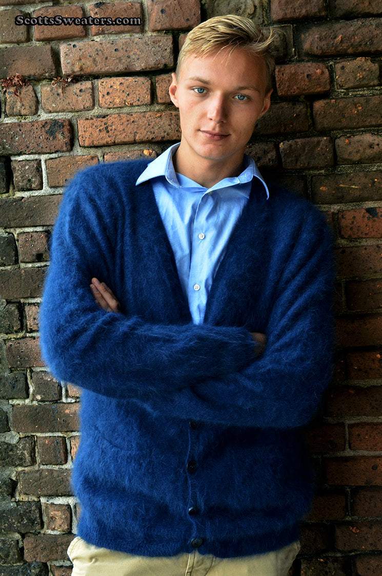Men's ultra-soft angora cardigan sweater in dark blue worn by man against brick wall background