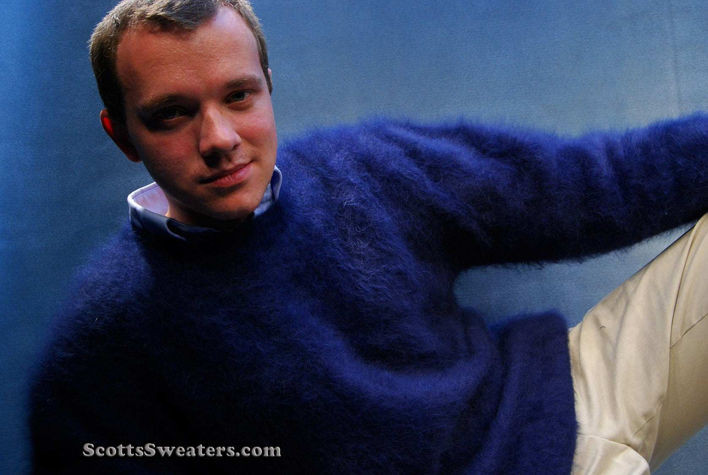 Men's ultra-soft angora crewneck sweater in navy blue worn by man sitting relaxed