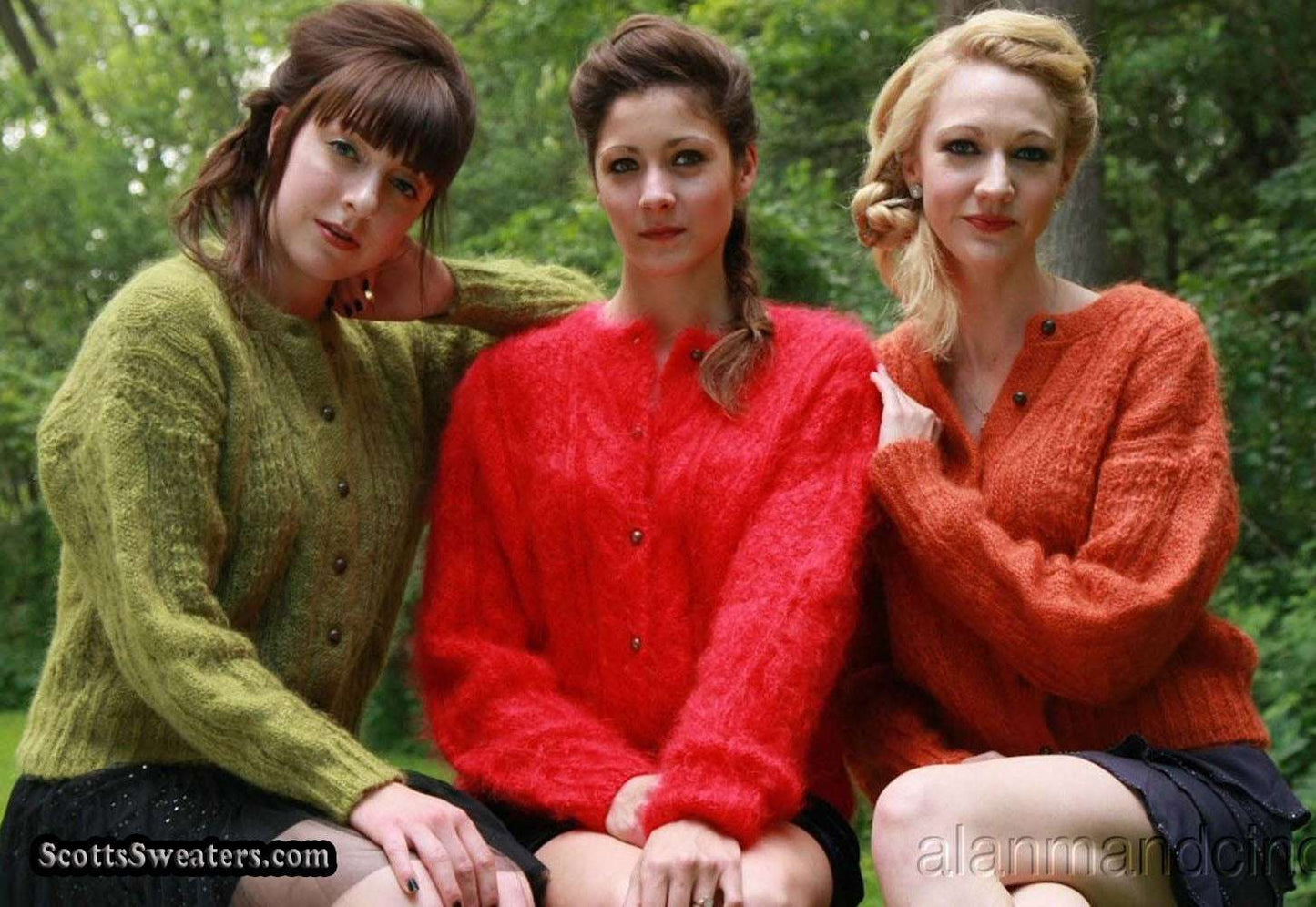 Three women outdoors wearing retro Italian mohair cable-knit cardigans in green, red, and orange colors