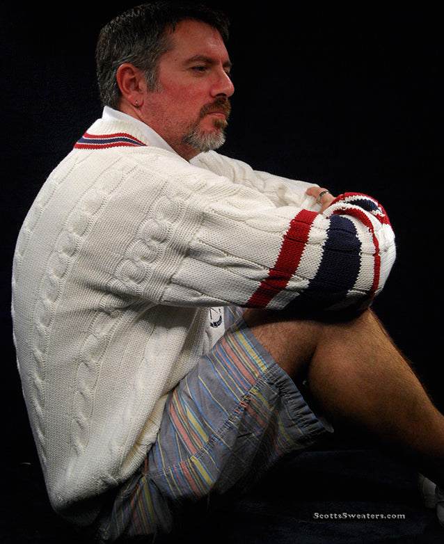 Men's sporty V-neck pullover cotton cable-knit sweater with red and navy striped trim and tennis rackets emblem.