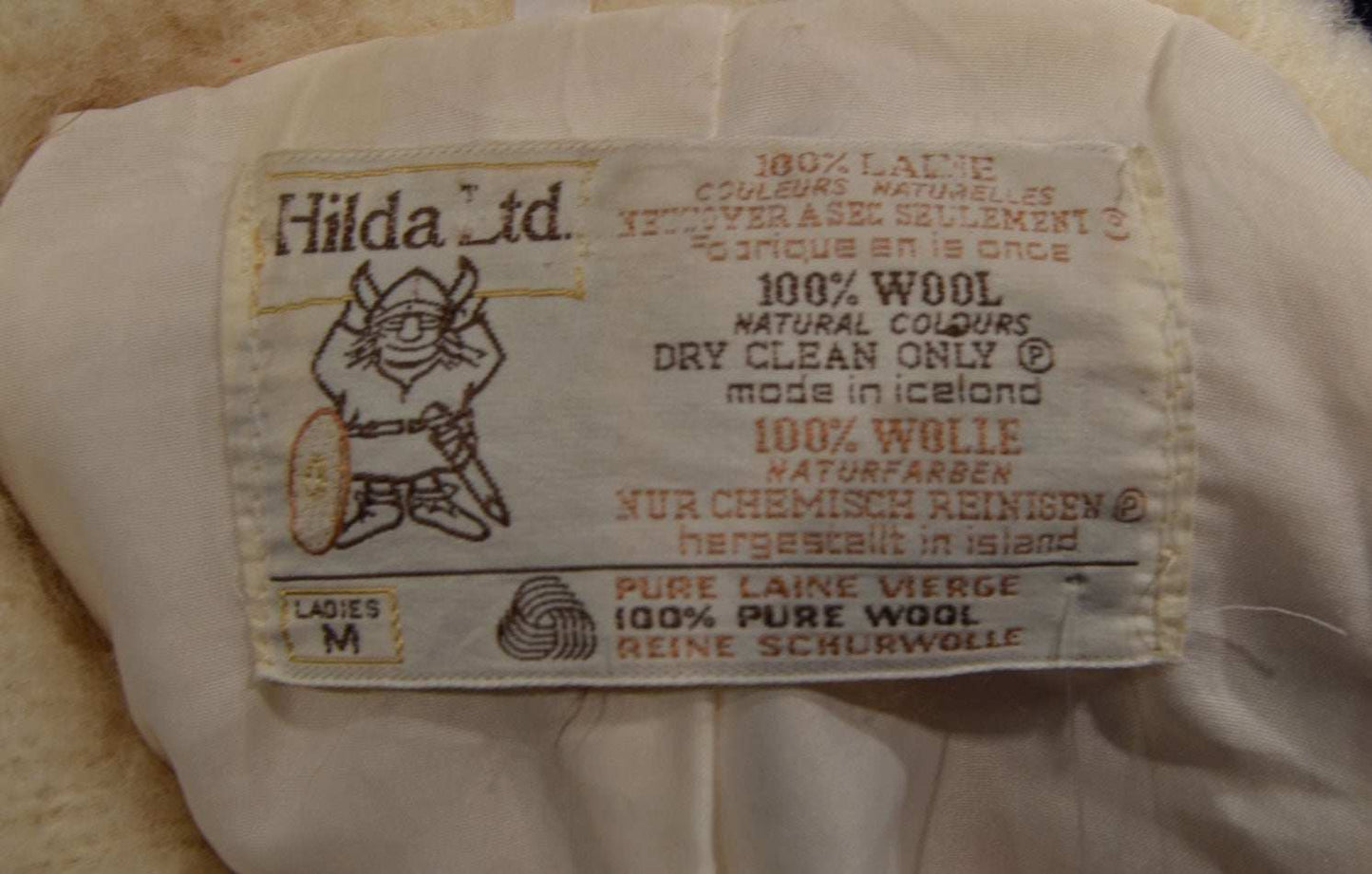 Label of Hilda Ltd Woman's Icelandic Wool Pea Coat showing 100% pure wool, made in Iceland, size medium, dry clean only.