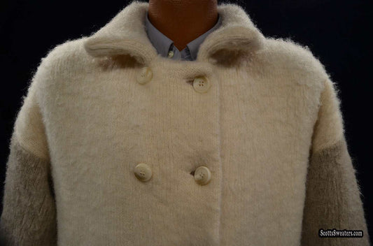 Ivory and tan double-breasted woman's Icelandic wool pea coat by Hilda Ltd with nylon lining displayed on a mannequin against black background