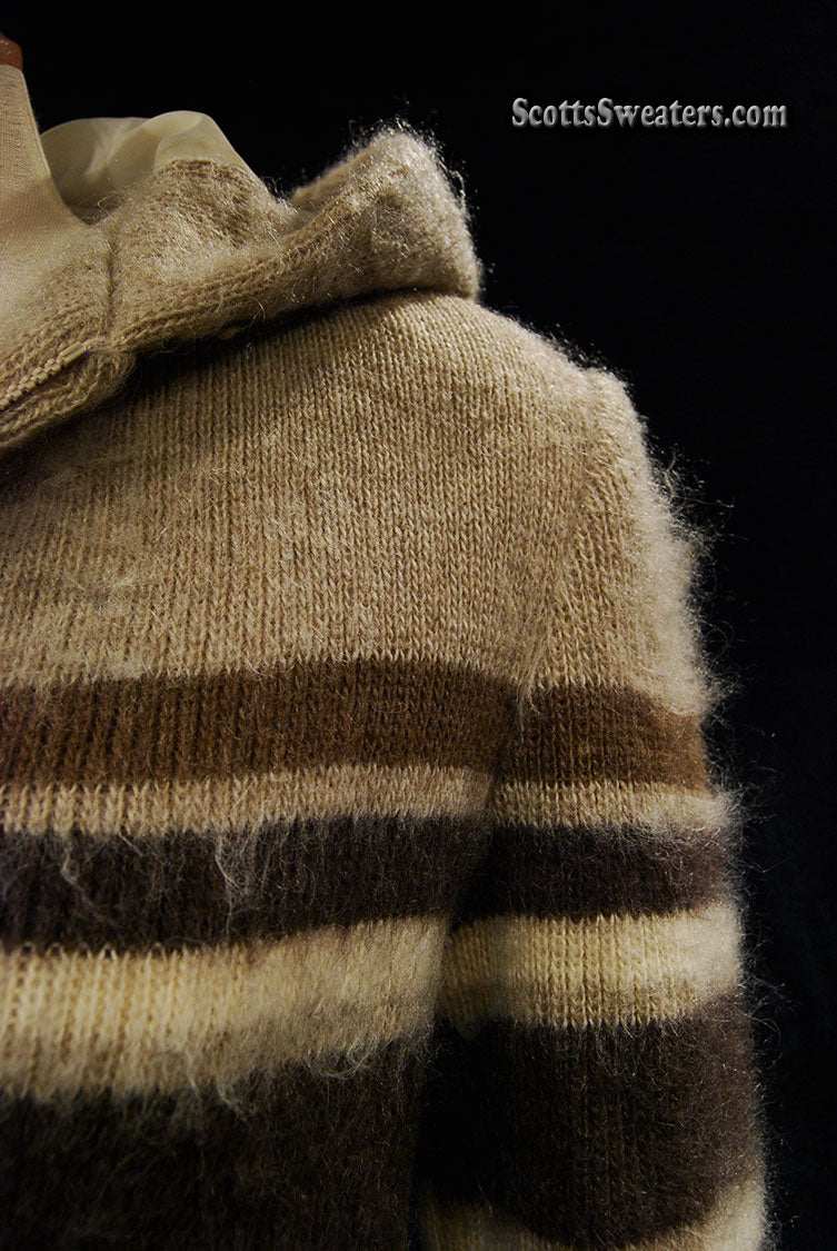 Close-up of tan woman's Icelandic wool coat with horizontal three-tone stripes and hood by Hilda Ltd.