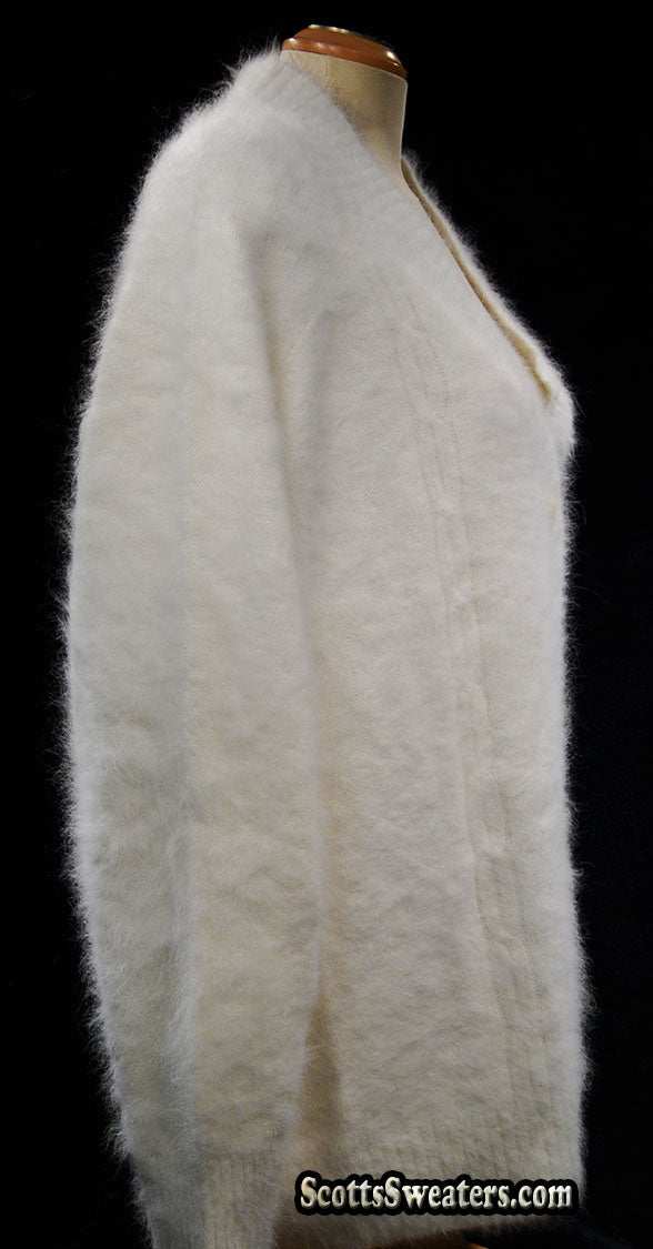 Woman's white angora shawl-neck cardigan sweater with single-button closure on mannequin
