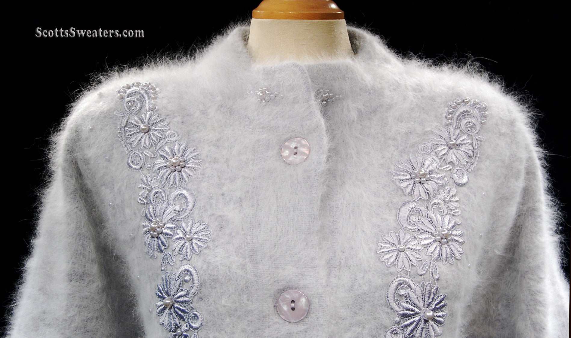 Woman's grey missy angora cardigan sweater with embroidered floral design and single-button closure on mannequin