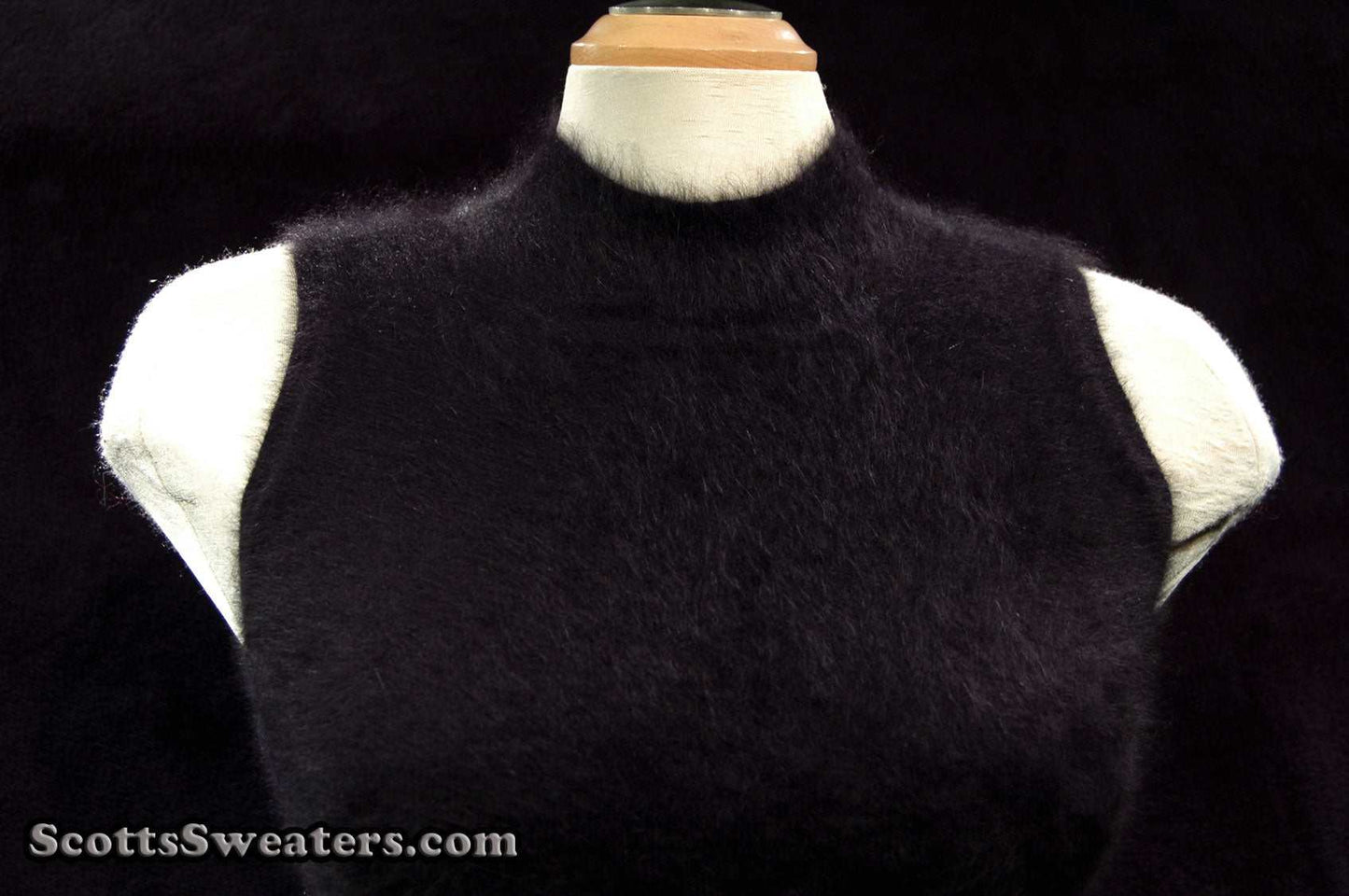 Sleeveless black angora sweaterdress by Next displayed on mannequin with high neck and cling-fit style