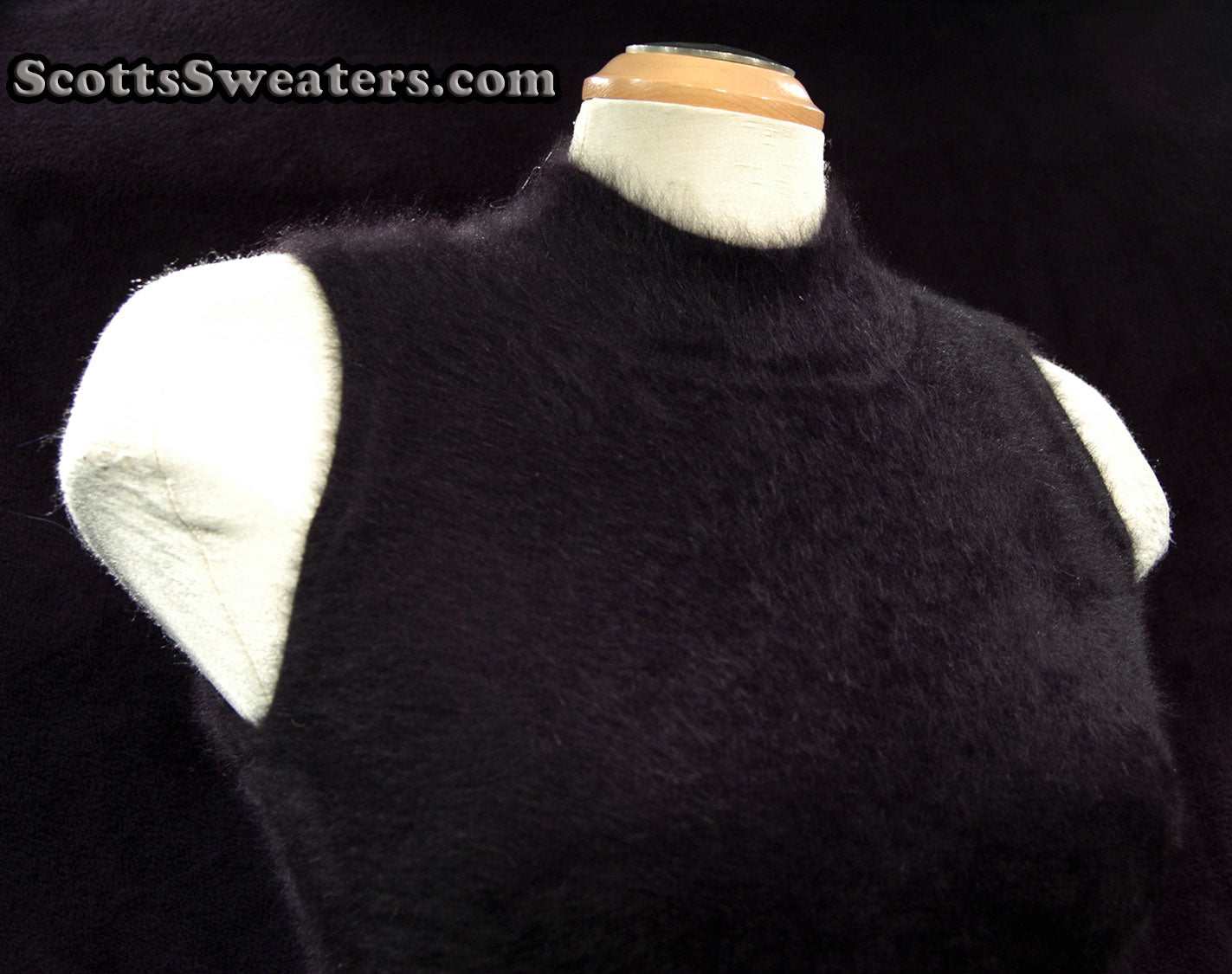 Sleeveless black angora sweaterdress displayed on mannequin