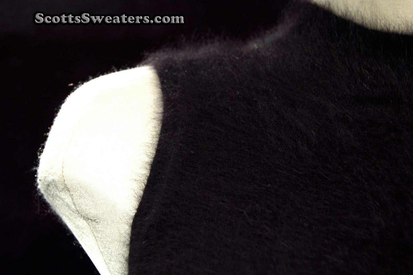 Close-up of black sleeveless angora sweaterdress fabric texture by Next, small size, cling-fit style