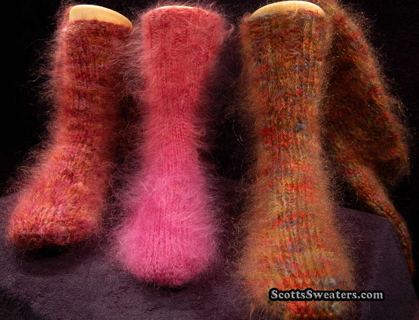 Colorful thick hand-knit fuzzy mohair socks in warm shades displayed on wooden sock forms
