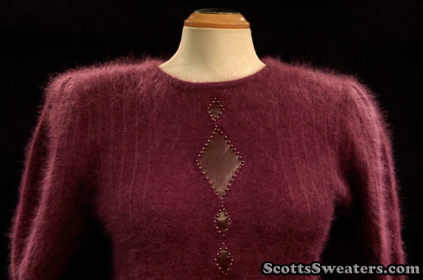 Deep-purple woman's 2-piece matching angora sweater set with short-sleeve sweater and open-front cardigan featuring leather design applique.