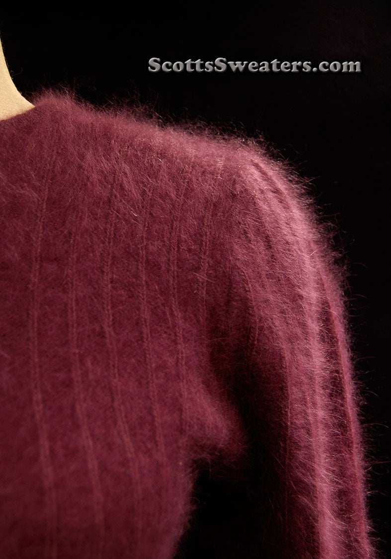 Deep-purple woman's 2-piece matching angora sweater set with short-sleeve top and open-front cardigan featuring leather appliqué.