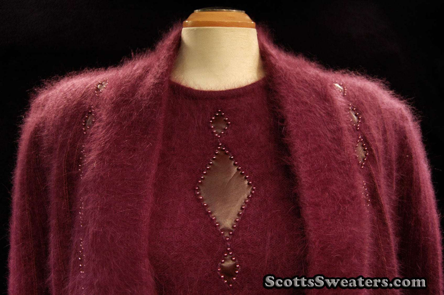 Woman's deep-purple 2-piece Angora sweater set with short-sleeve sweater and open-front cardigan featuring leather diamond appliqué.