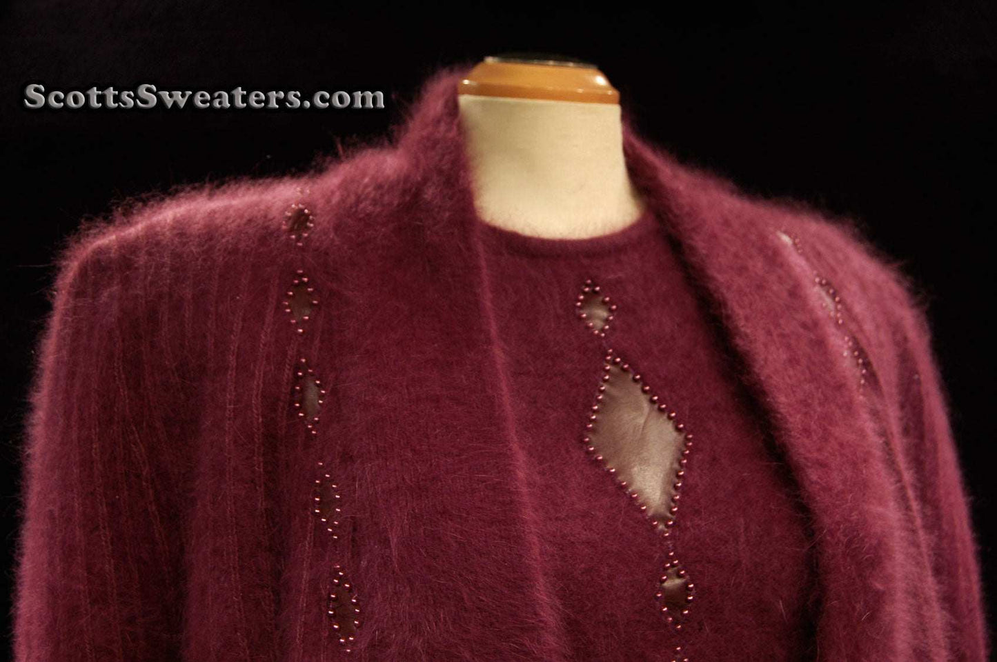 Deep-purple woman's 2-piece matching Angora sweater set with short-sleeve sweater and open-front cardigan featuring leather design appliqué.