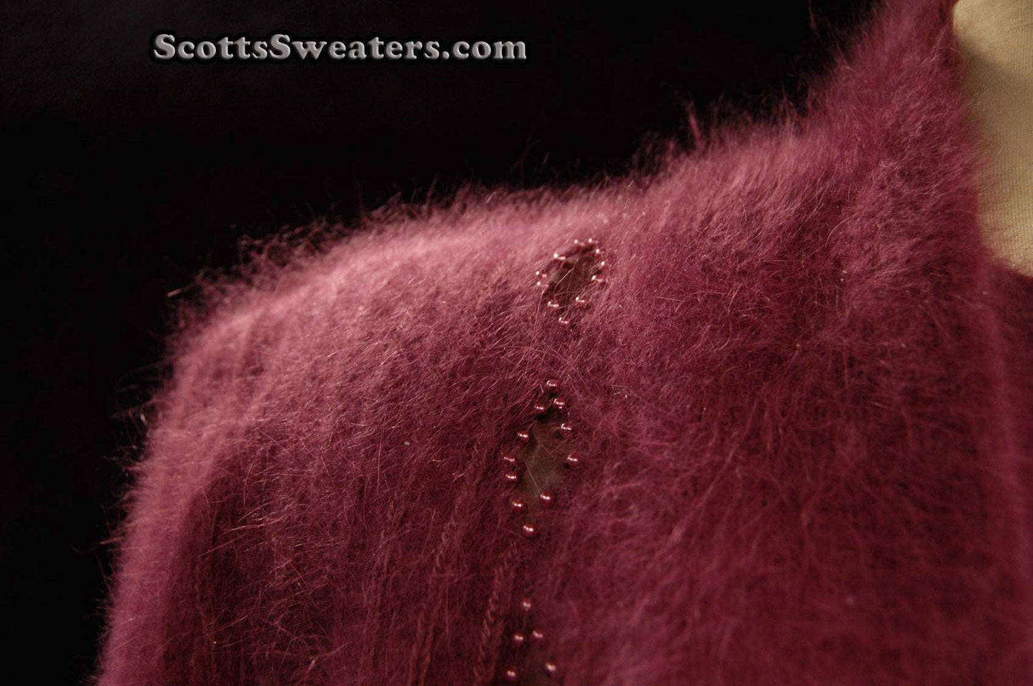 Deep-purple woman's 2-piece matching Angora sweater set with short-sleeve sweater and open-front cardigan featuring leather design appliqué.