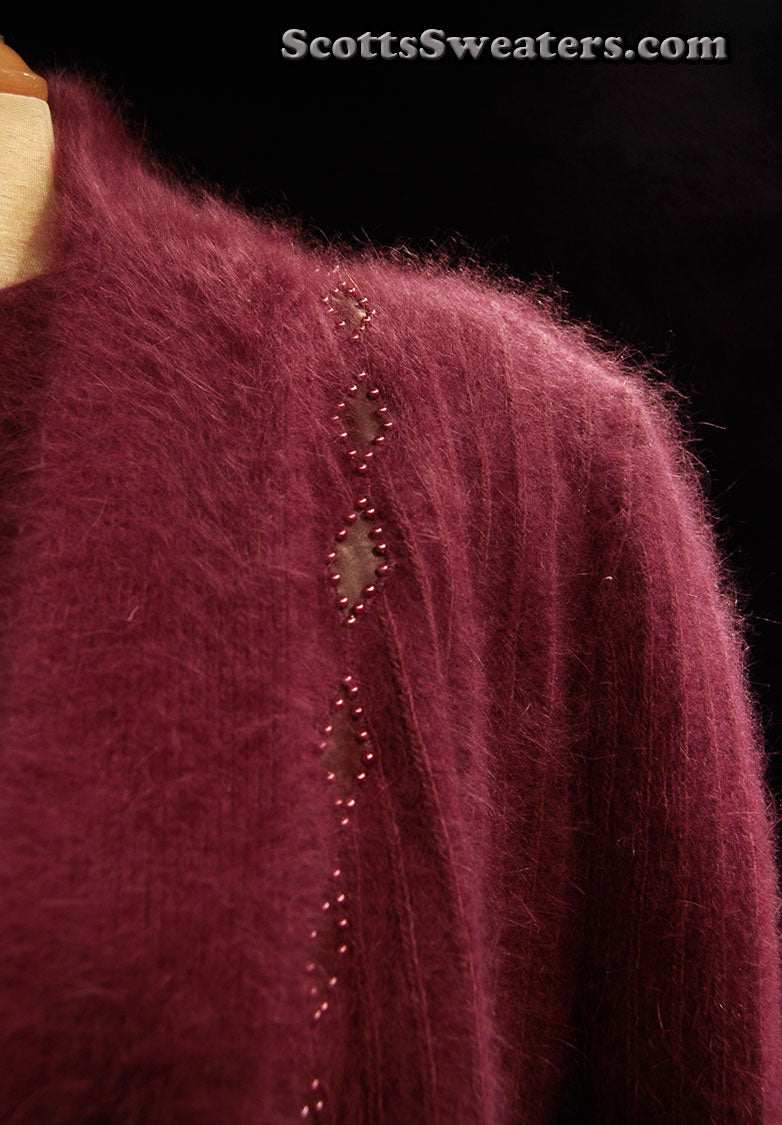 Deep-purple woman's 2-piece matching angora sweater set with short-sleeve sweater and open-front cardigan featuring leather design appliqué.