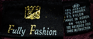 Woman's 2-piece matching deep-purple Angora sweater set with short-sleeve top and open-front cardigan featuring leather appliqué