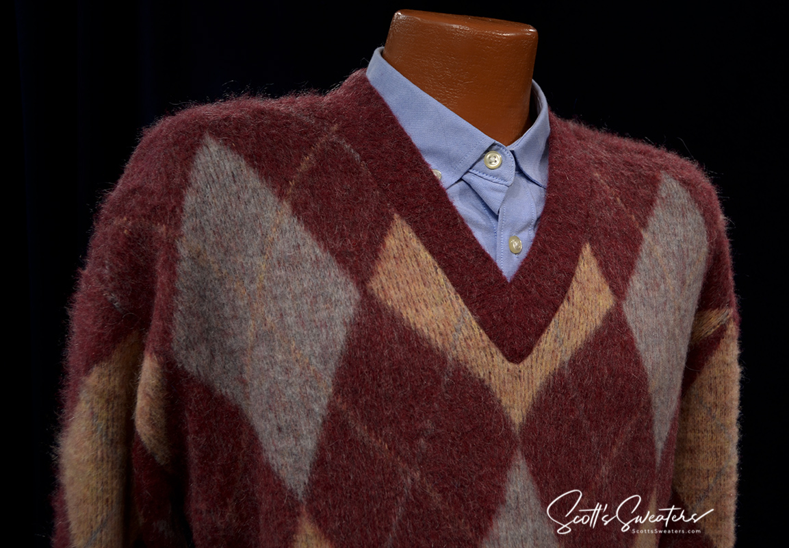 Retro shaggy mohair V-neck sweater with three-color argyle pattern in red, gray, and beige on mannequin.