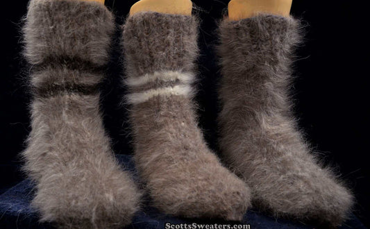 Three pairs of thick, hand-knit Siberian Angora socks in soft, fuzzy gray wool against a dark background