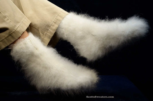 Hand-knit thick and warm white Siberian Angora socks with a soft fuzzy texture worn with beige pants