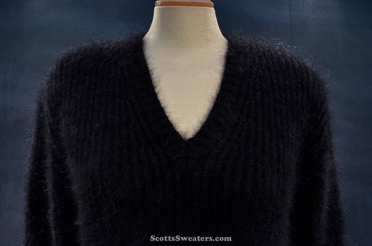 Women's black V-neck angora sweater by Michael Kors displayed on mannequin