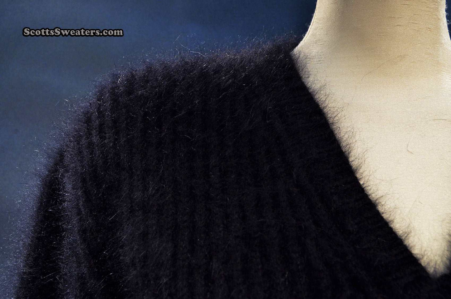 Woman's black V-neck angora sweater by Michael Kors displayed on mannequin