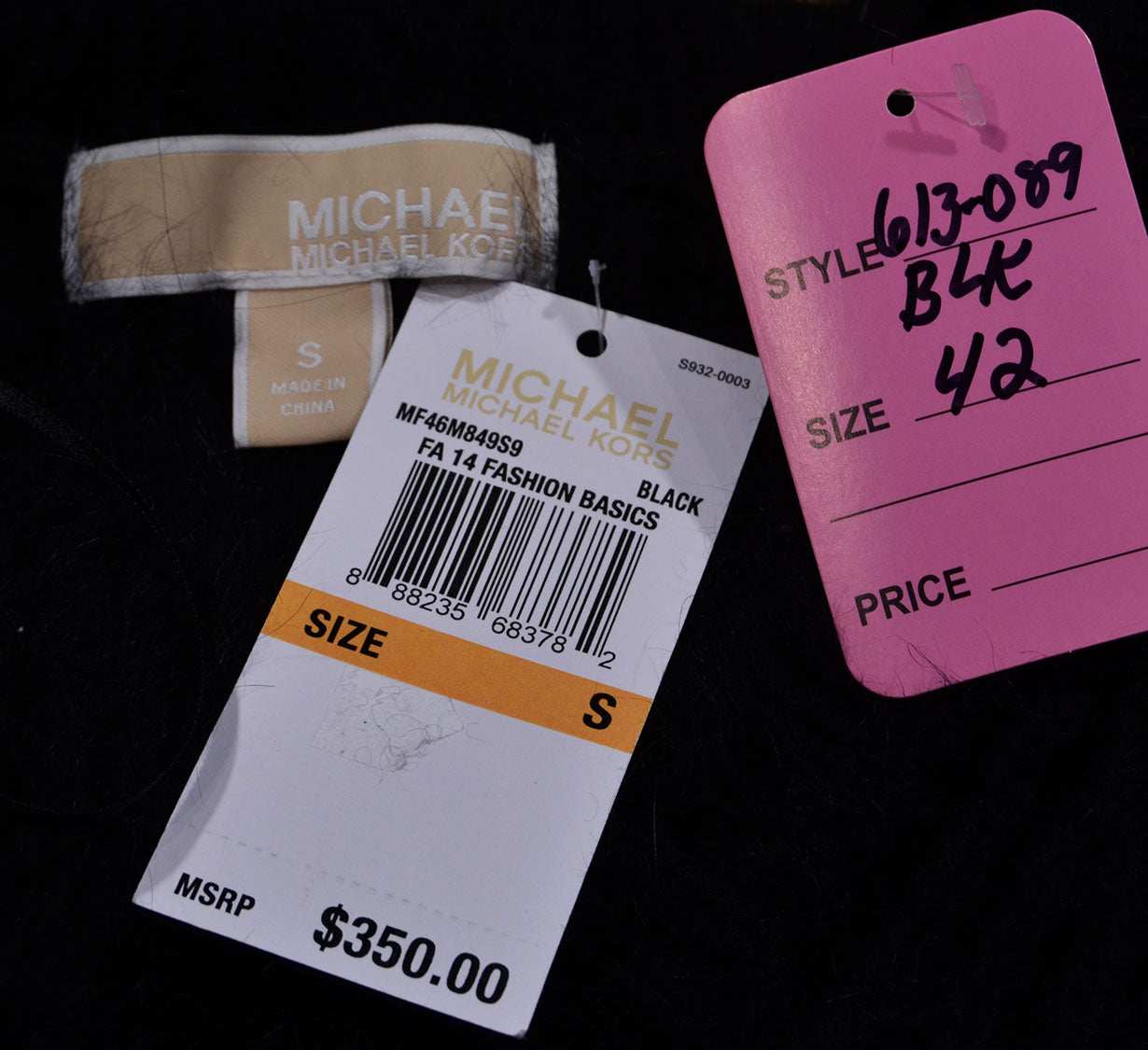 Black Michael Kors sweater size small with price tag showing $350 and style labels