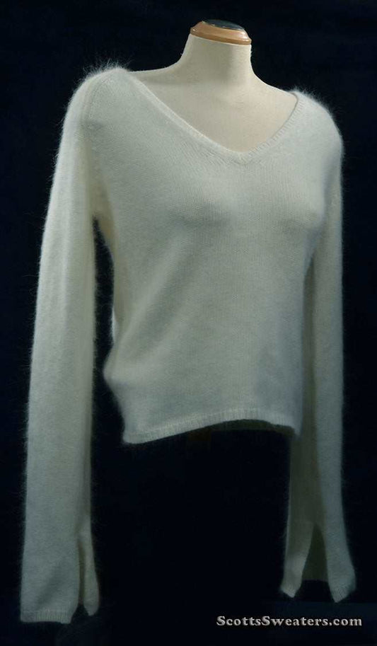 Woman's white angora V-neck sweater with split cuffs by H&M on mannequin