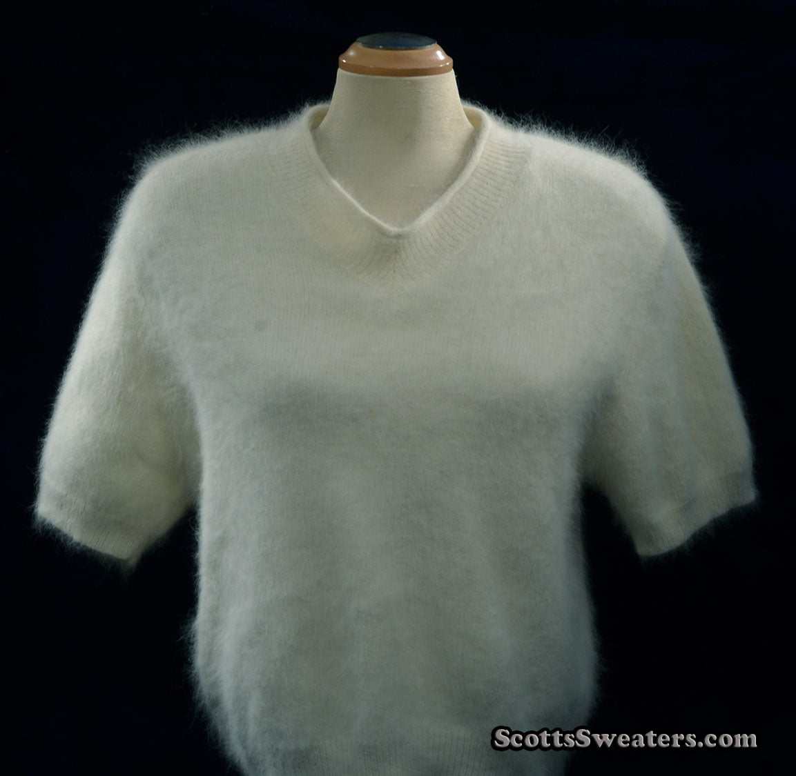 Woman's white short-sleeved V-neck angora sweater by Just Clothes on mannequin