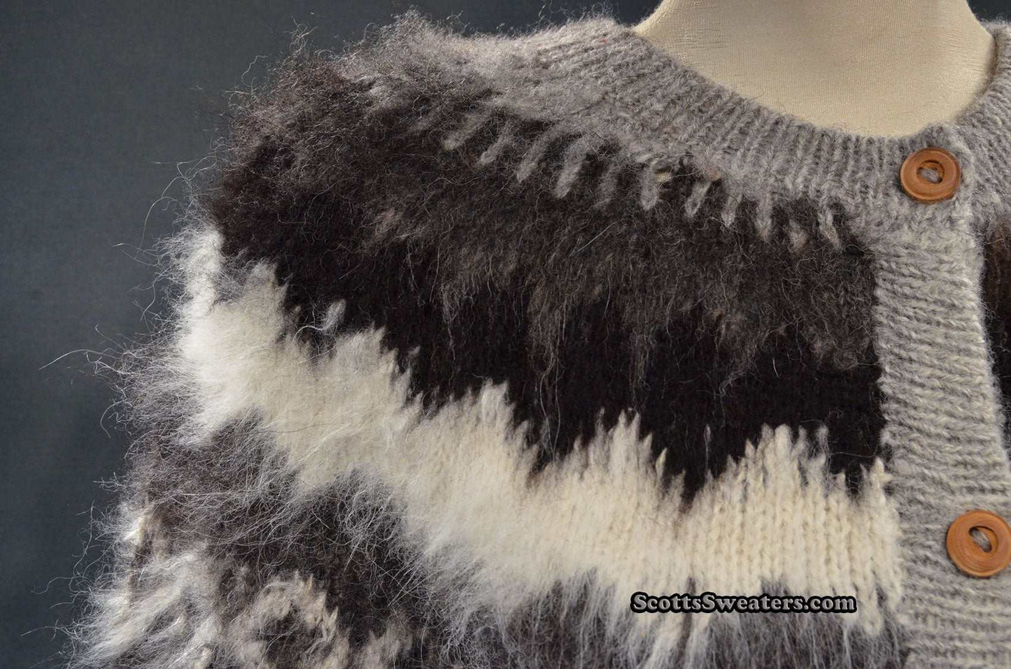Close-up of woman's grey ultra-soft alpaca cardigan sweater with grey-white-black yoke design and wooden buttons