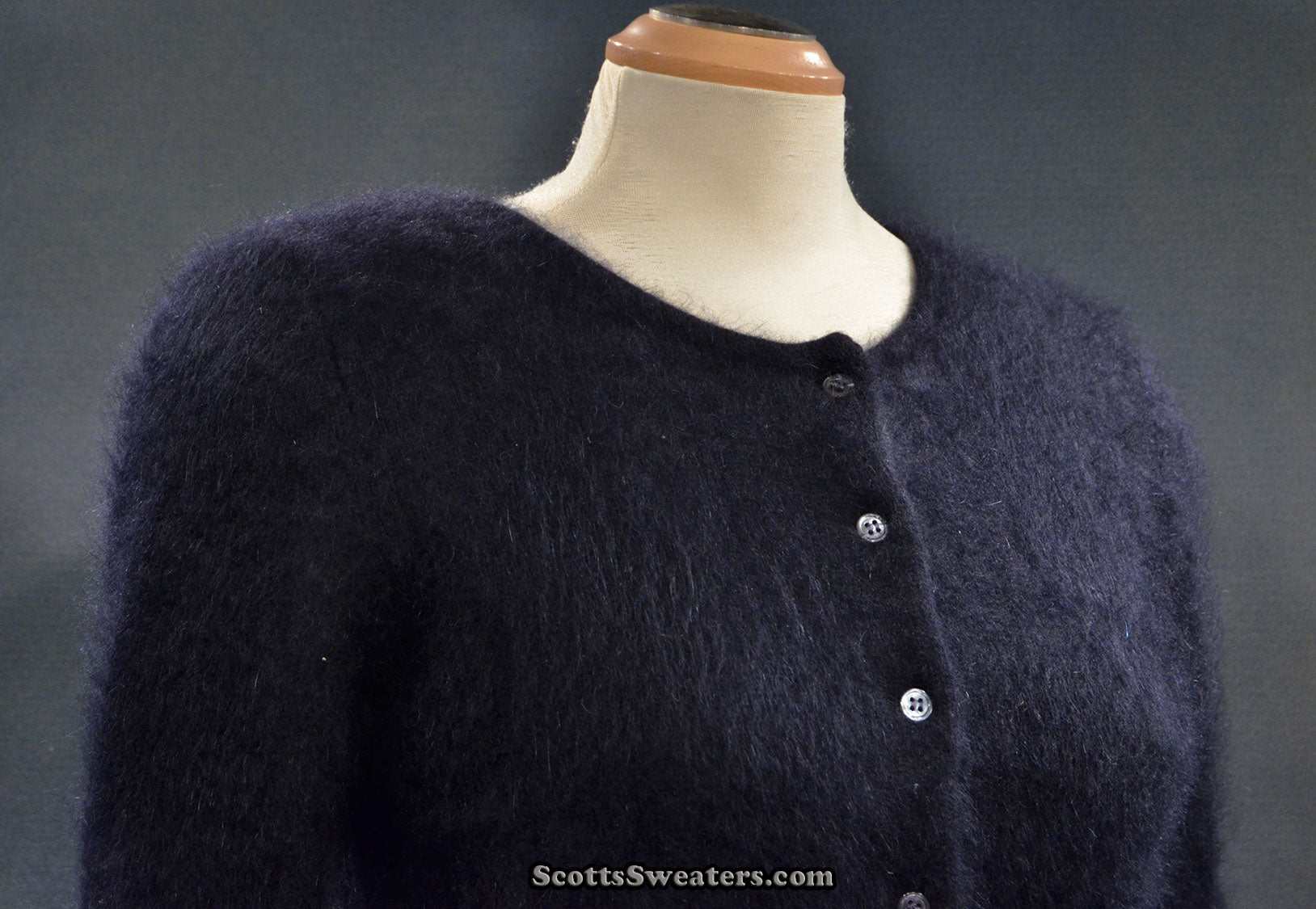 Girl's large black angora cardigan sweater by BCBD Max Azria on mannequin