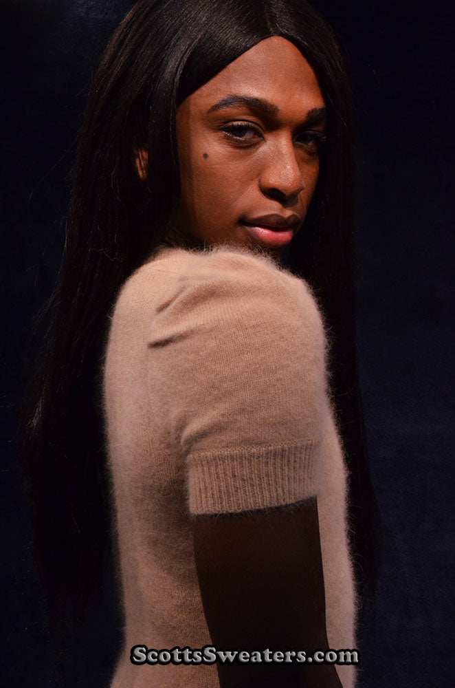 Tan angora sweaterdress by MODA International in soft tan color worn by model against dark background