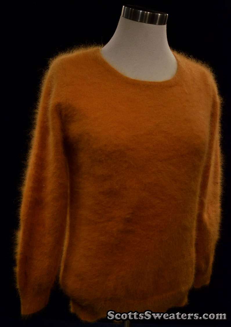 Woman's golden roundneck soft and fuzzy angora sweater on mannequin