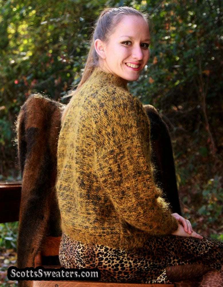 Woman wearing a gold and black tweed mohair crewneck sweater outdoors