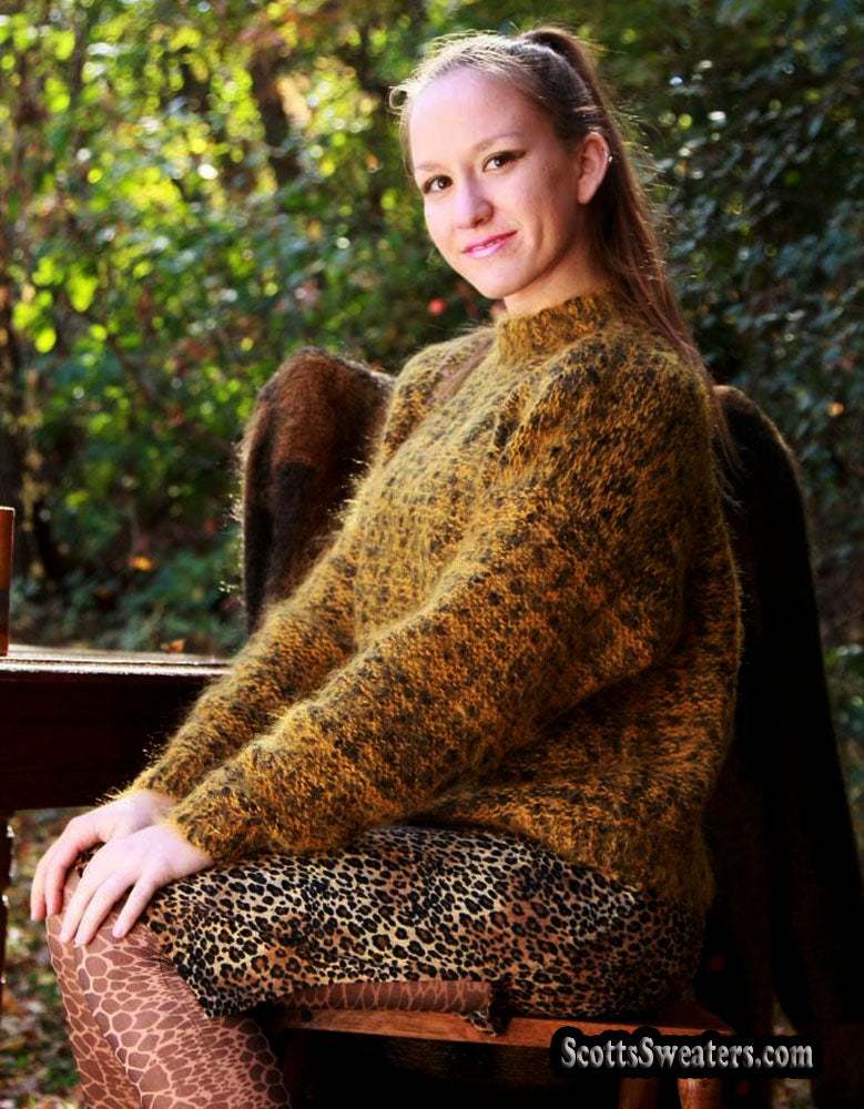Woman wearing small gold and black tweed mohair crewneck sweater sitting outdoors
