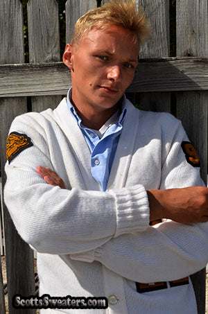 Man wearing retro classic letterman sports cardigan sweater in white with patches on sleeves