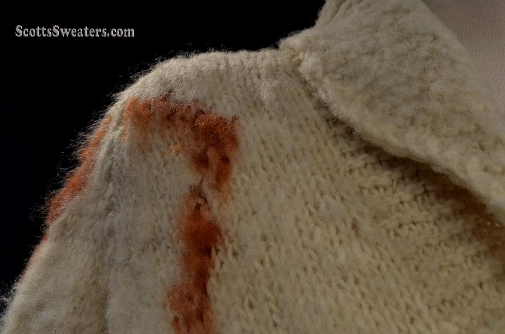 Close-up of woman’s fuzzy Nepal wool hand-knit cardigan sweater with shawl collar and brown diamond knit design