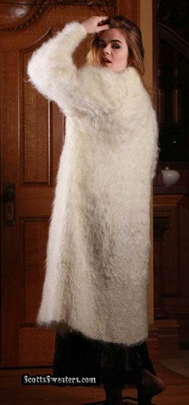 Woman wearing ivory full-length mohair sweater-coat by Arundell UK in elegant indoor setting