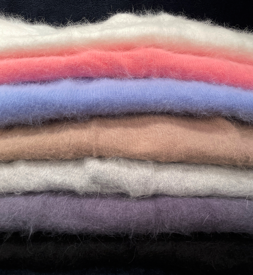 Stack of soft woman's short angora skirts in various colors with elastic waistbands