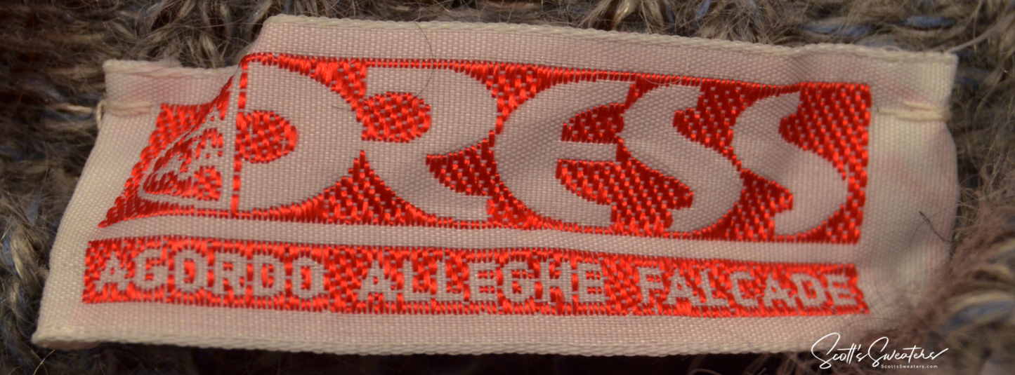 Close-up of red and white Dress brand label on grey angora cardigan sweater