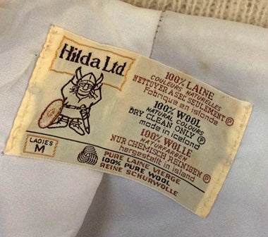 Label of Woman's Icelandic Wool zipper-front coat by Hilda Ltd showing material and size details