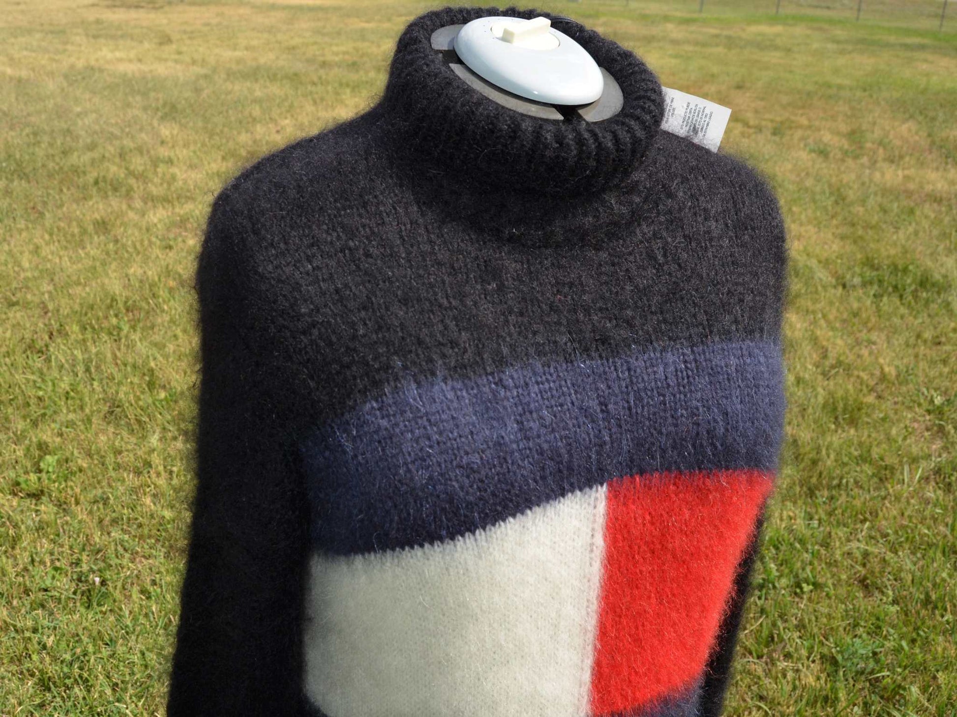 Woman's fuzzy mohair sweaterdress with turtleneck and Tommy Hilfiger logo in black with red, white, and blue color blocks.