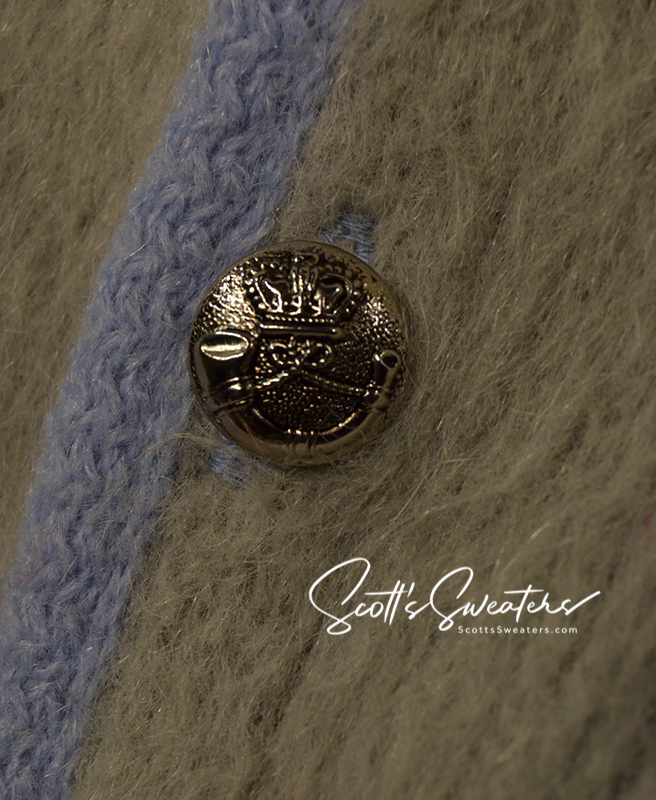 Close-up of metal button on four-color classic men's retro mohair cardigan sweater with blue and tan stripes by Puritan Sportswear