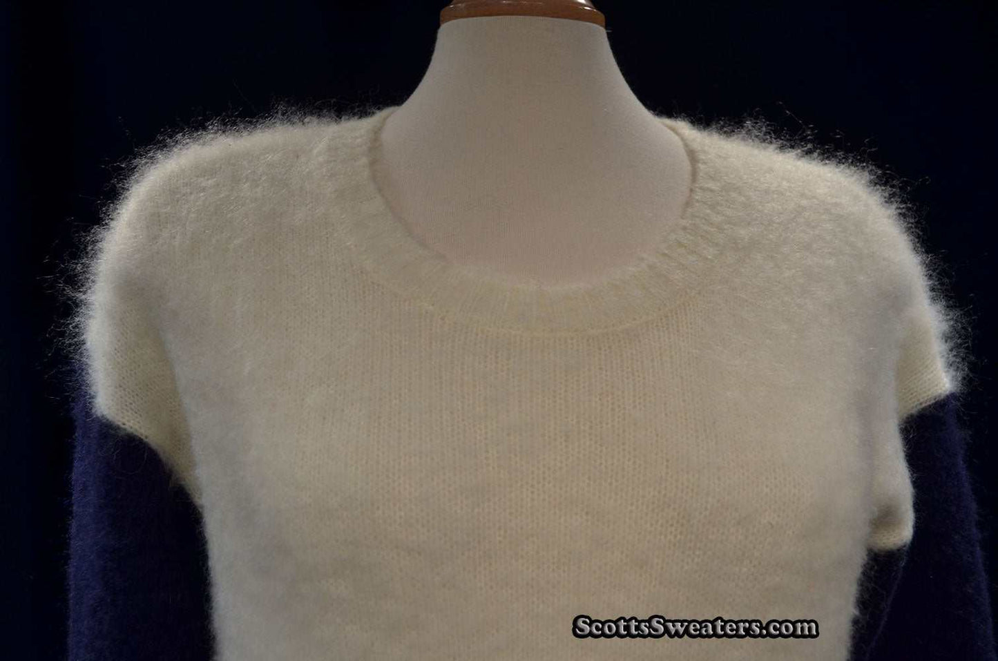 White fuzzy roundneck mohair color-block sweater with navy sleeves on mannequin