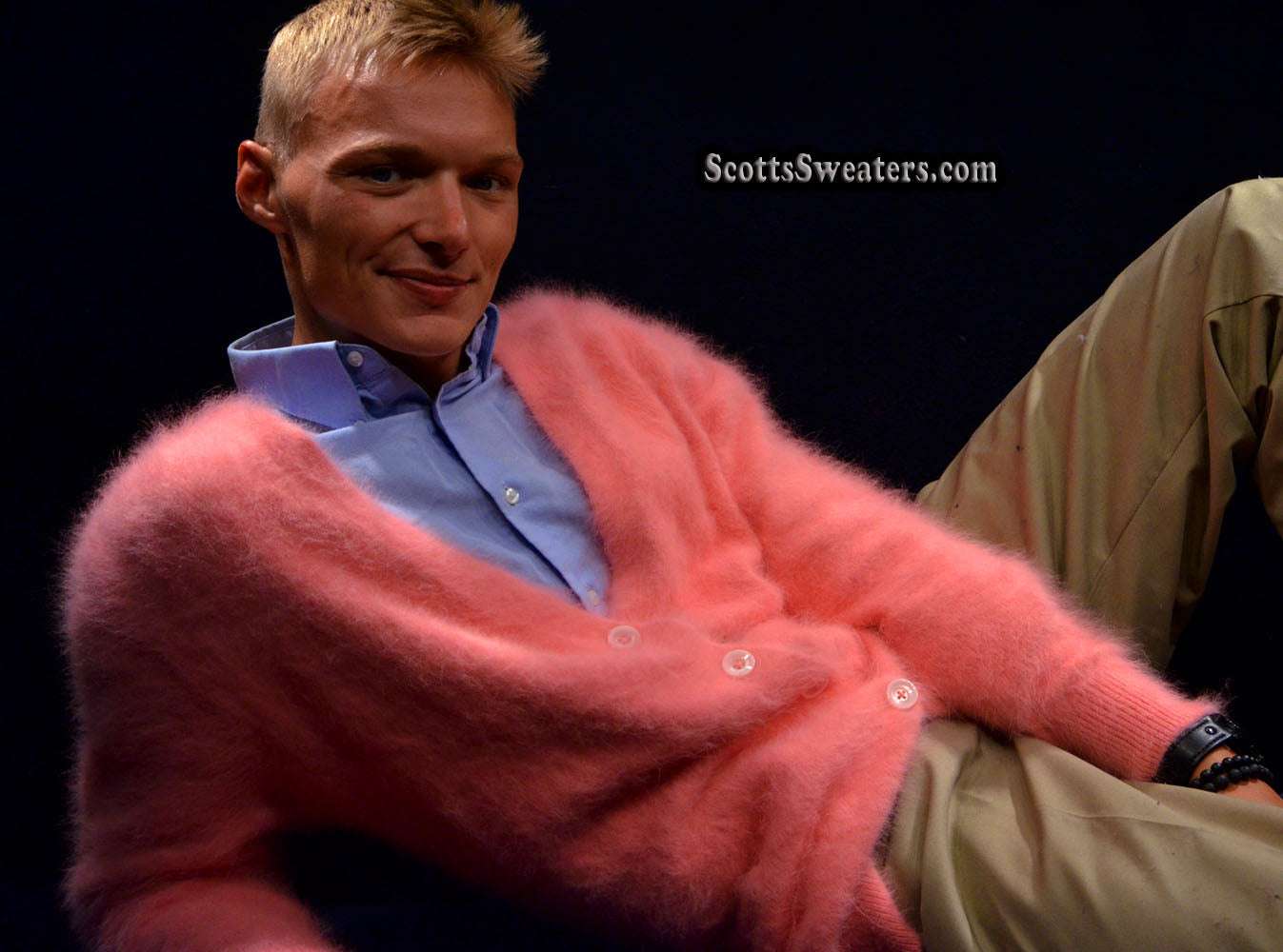 Men's ultra-soft angora cardigan sweater in pink worn with blue shirt and beige pants