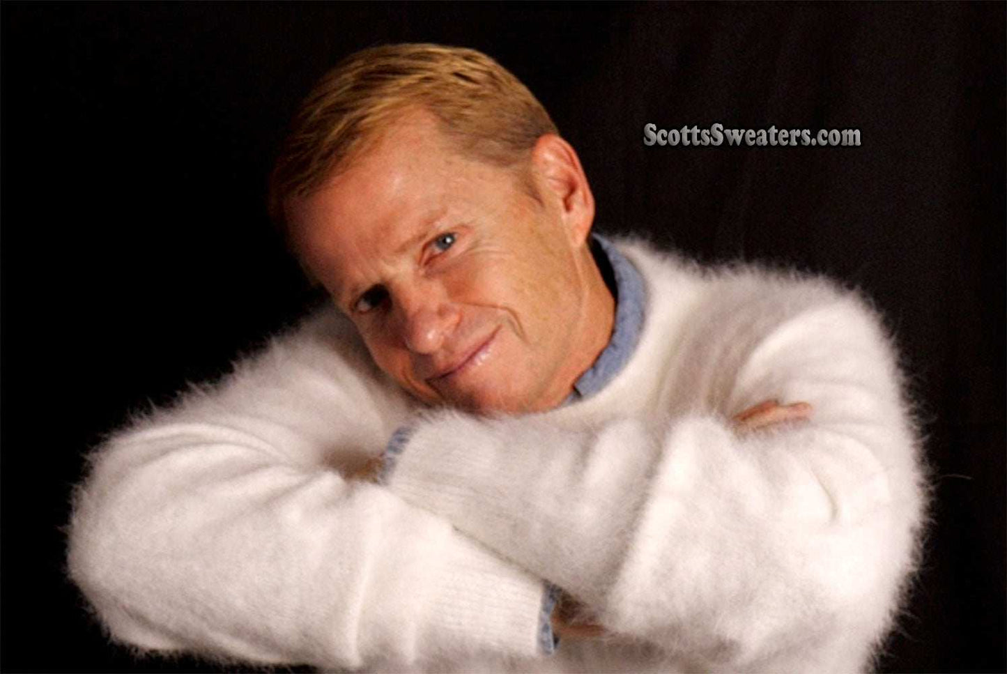 Men's ultra-soft white angora crewneck sweater worn by smiling man against black background