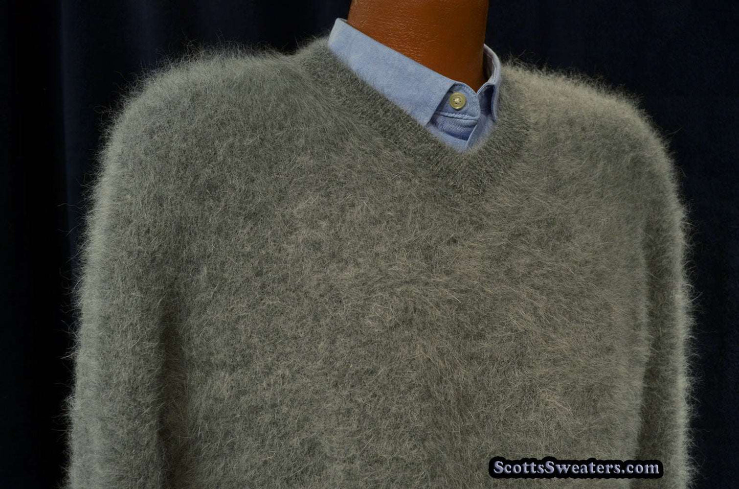 Men's ultra-soft angora V-neck sweater in gray with a light blue shirt underneath on a mannequin.