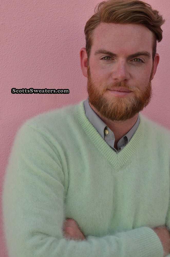 Man wearing a light green men's ultra-soft angora V-neck sweater against a pink background
